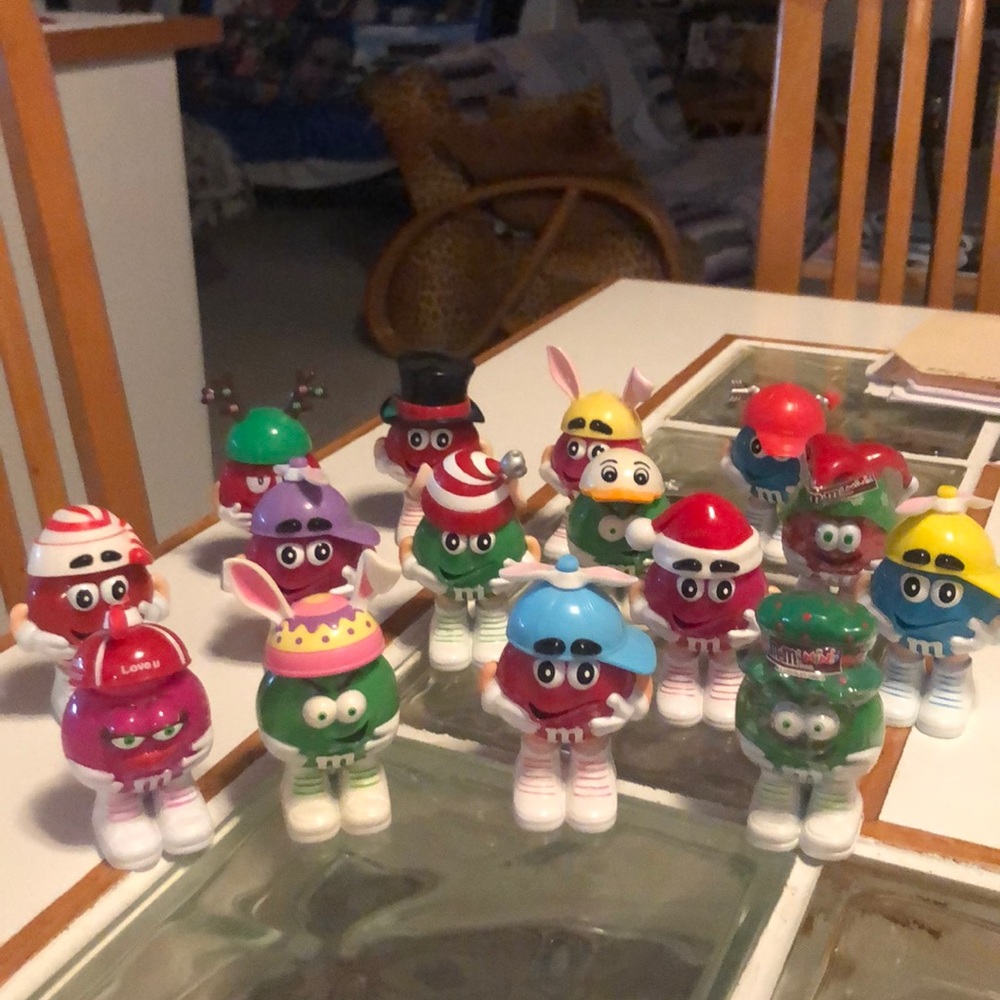 Collectible M&M people wearing assorted hats.