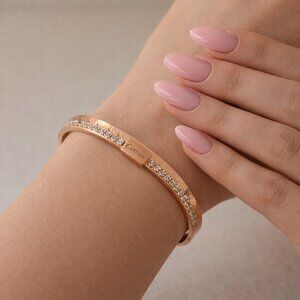 Rose colored bracelet W/ crystals highlights opens with pull. New without tags.