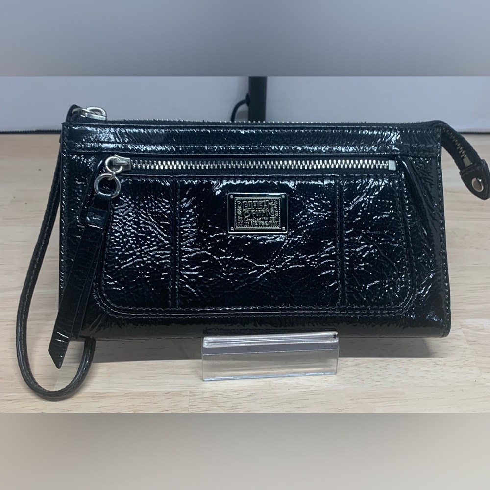 Coach Poppy Black patent leather wristlet with pink poppy interior.