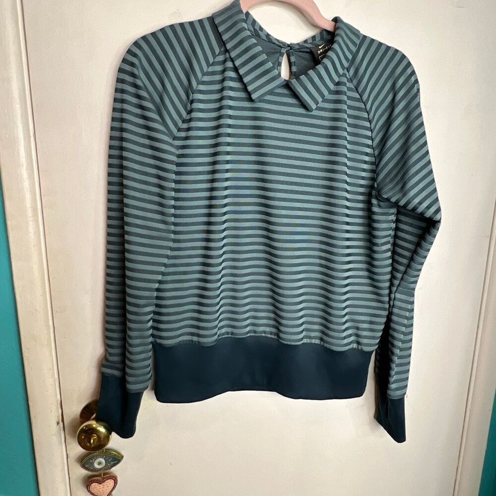 Nike long-sleeved athletic shirt with a striped pattern and collared neckline.
