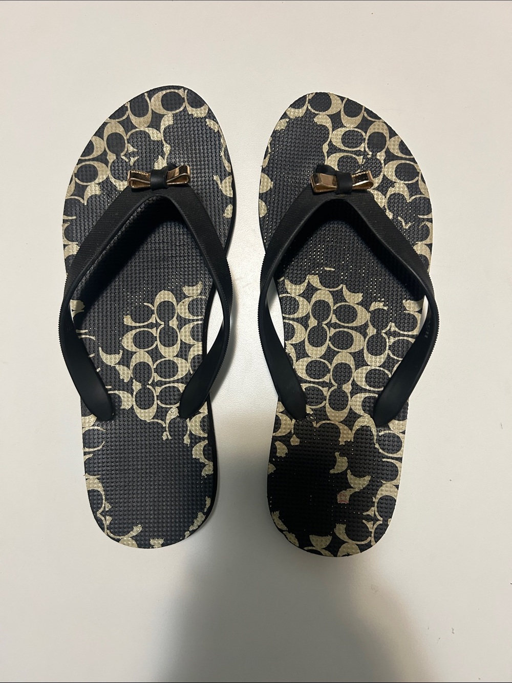 Coach Black Flip Flops with Gold Bow Accent