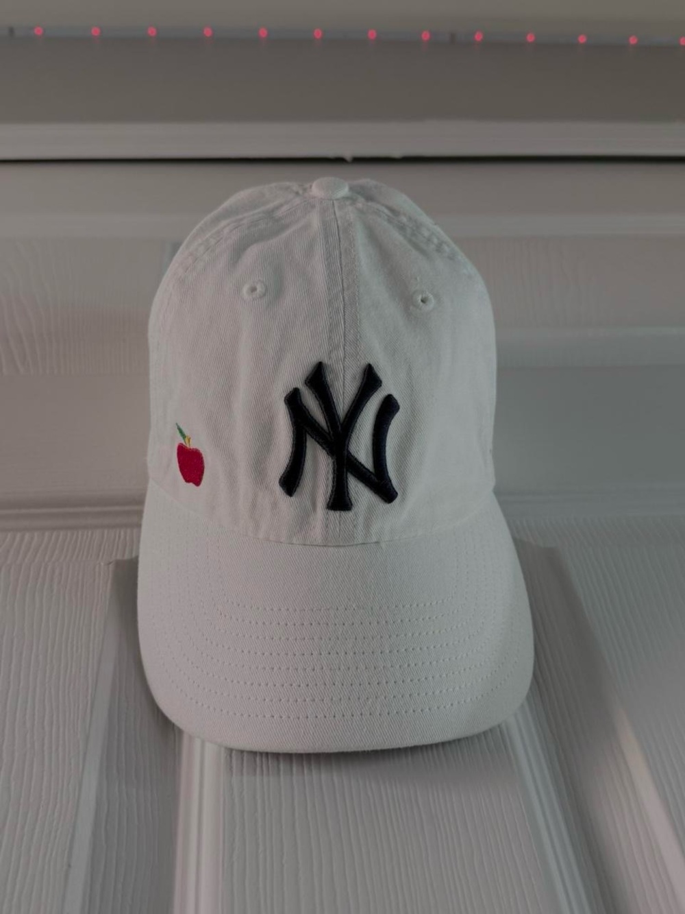 White NY Embroidered Baseball Cap with Red Apple Accent
