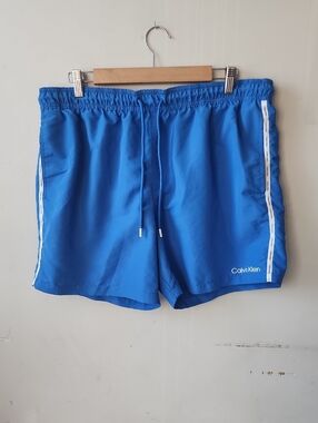 Calvin Klein Blue Swim Trunks with White Side Tape. New Without Tag